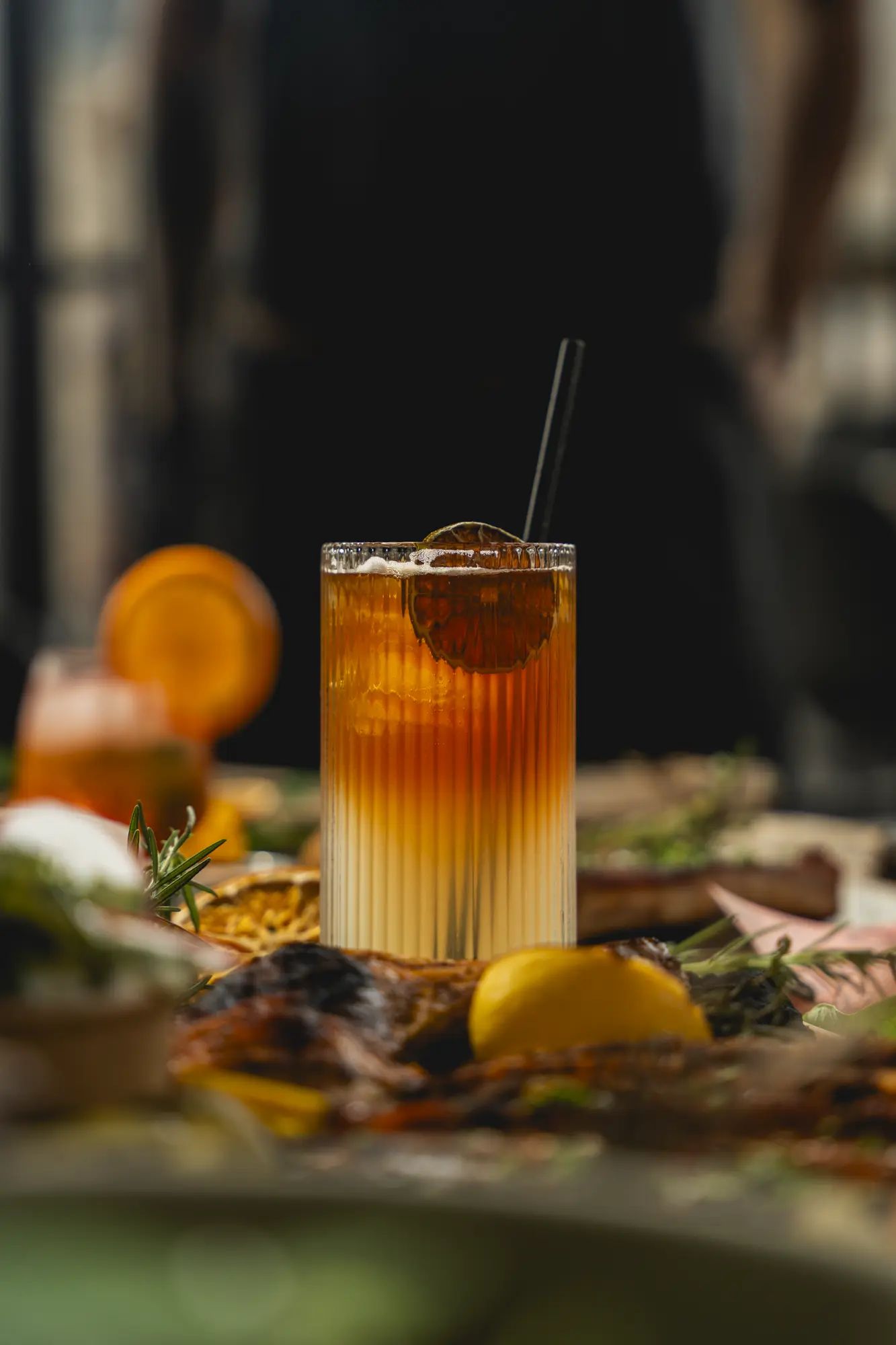 A layered citrus cocktail served alongside smokehouse dishes